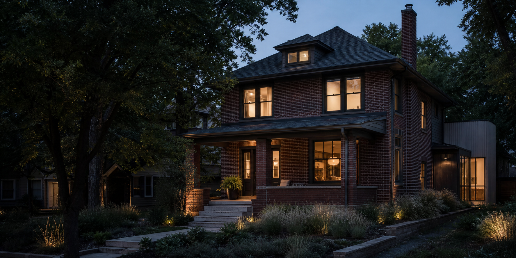 A sensitively renovated brick home at dusk